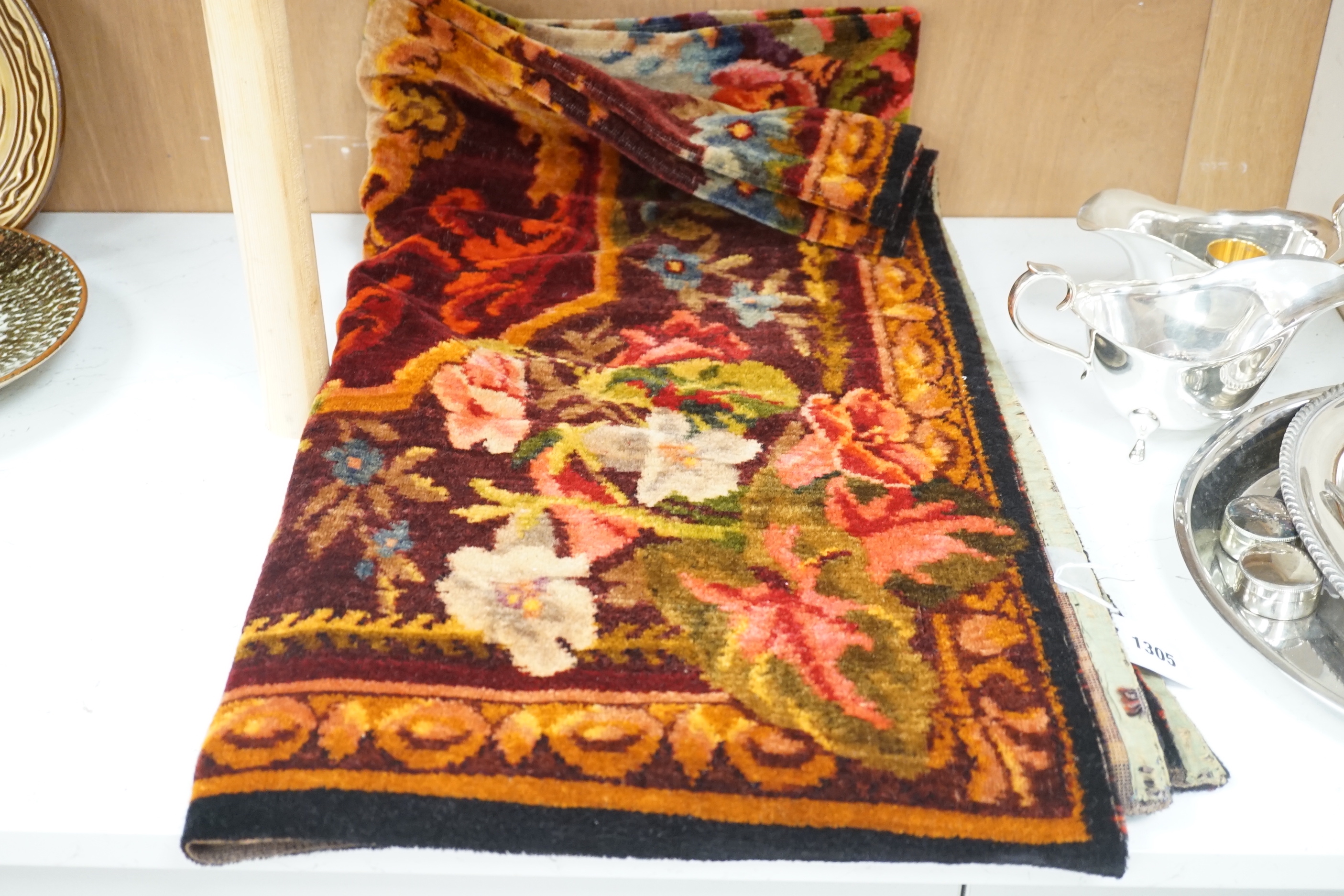 An early 20th century woven multi coloured plush floral piano or table cover